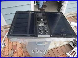 Jenn air downdraft cooktop with black glass burners and grill unit